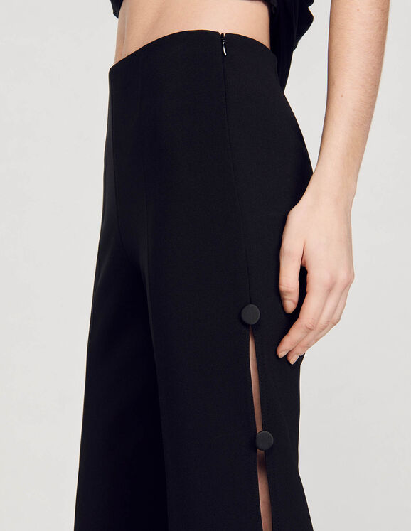 Flared trousers with cutaway sides