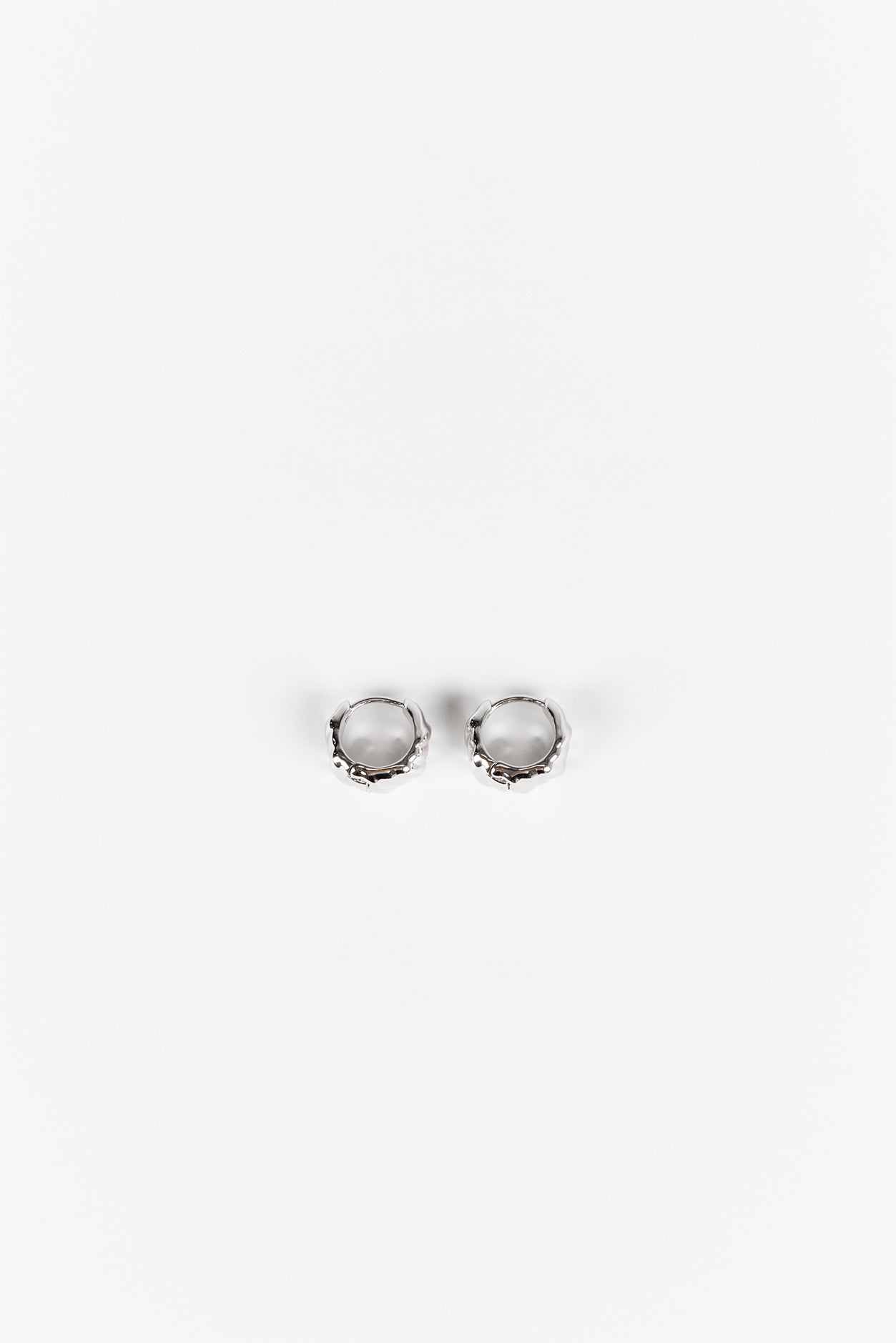 LUV AJ HAMMERED SILVER HUGGIE EARRINGS