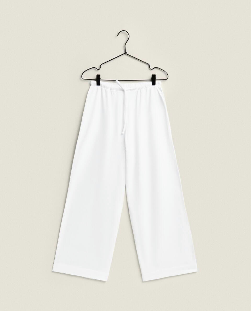 TROUSERS WITH PIPING